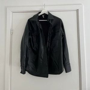 skinnjacka st36 - jacka i skinnliknande material i st36 från Nelly. Den är lite fodrad på insidan och band att knyta runt midjan tillkommer. Jackan har endast använts ett antal gånger så är fortfarande i bra skick. 