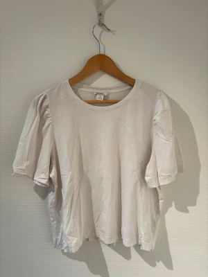 T-shirt med ”puffärm” - Vit T-shirt med ”puffärm” från Monki🤍.                      Storlek M