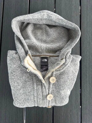 The north face - Cozy and warm - Grey - Size S - • The North Face hoodie • Size Small, fits true to size • Heather grey • Cozy fleece material • Button and zip neck closure • Front pockets • Very good used condition • No visible flaws or stains • From a smoke and pet free home • Perfect for layering