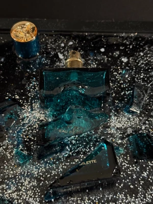 Handgjord Epoxy Tavla – Krossad Versace eros - Handgjorda epoxy-konsttavlor med 3D-effekt  • Krossad Versace parfym flaska i epoxy  Unika konstverk, perfekta som inredningsdetalj eller present. Säljs styckvis eller tillsammans. Skickas väl emballerade eller hämtas enligt överenskommelse.