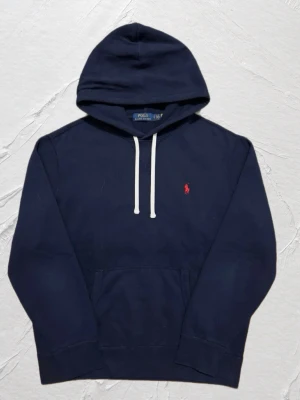 Marinblå Ralph Lauren hoodie  - OBS! Pris kan sänkas till 899,lägsta priset!                   Stilren och väldigt fräsch hoodie,väldigt bra skick. Storlek: S-Xs : | Skick: 9/10 | Färg: Marinblå| //Mvh Deluxe fa$hion