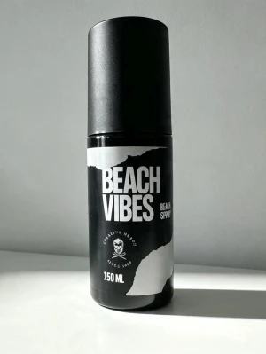 Beach Vibes Beach Spray 150 ml - Beach Vibes Beach Spray är en svart sprayflaska med vit text och grafisk design. Flaskan rymmer 150 ml och har en modern, stilren look. Perfekt för dig som vill skapa en avslappnad strandkänsla i håret.