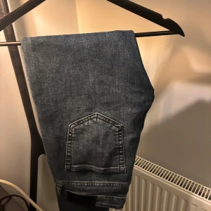 Mörkblå slim jeans från Dressmann - Snygga mörkblå jeans från Dressmann i slim fit-modell. Klassisk femficksdesign med smal passform och diskreta slitningar. Perfekta för dig som gillar en stilren och enkel look. Jeansen är tillverkade i ett mjukt och stretchigt jeanstyg för extra komfort. Aldrig använda