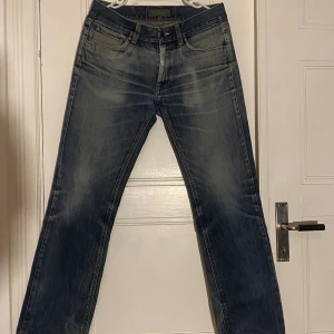 Acne Studios Jeans - Säljer ett par klassiska blå jeans med snyggt slitna detaljer och raka ben. Storlek 32/32