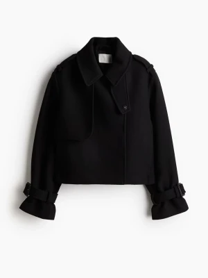 Svart trenchcoat jacka - Säljer en svart jacka med bred krage och snygga spänndetaljer vid ärmsluten. Jätte fin till alla olika tillfällen.