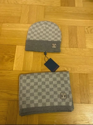 Grå mössa och Sjal - En helt ny grå mössa som kommer med en matchande sjal.