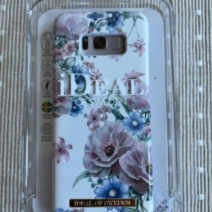 iDeal of Sweden Galaxy S8 Skal - Elegant och lättviktigt mobilskal med blommigt mönster, designat för Samsung Galaxy S8. Slimmad design, kompatibel med trådlös laddning. Skalet är nytt i originalförpackning och skyddar din telefon med stil.