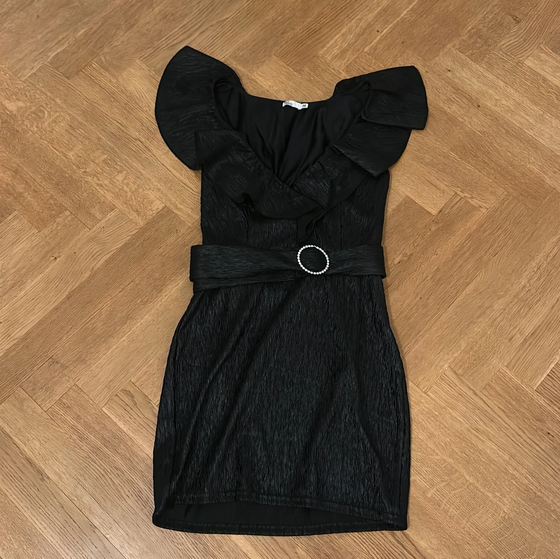 Svart kort klänning med volang