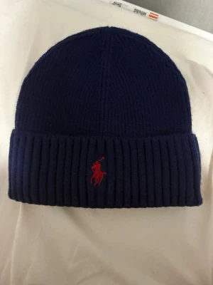 Marinblå mössa Polo Ralph Lauren - Polo Ralph Lauren mössa. Inte använd 