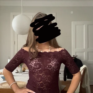 Vinröd offshoulder  - Vinröd off shoulder topp som är i nyskick då den knappt är använd. Den sitter tajt mot kroppen. Fint mönster!  