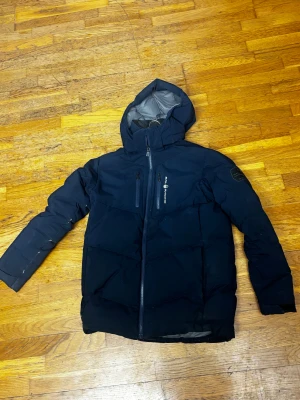 Mörkblå Sail Racing dunjacka - Jätte fin jacka som räddar kalla vinter dagar, enda nackdel är att de finns ett hål där bak som finns i bilderna.  (Samt att priset kan sänkas vid en snabb affär) Köpt för 3499kr