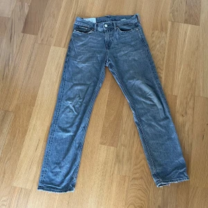 Grå relaxed jena’s h&m - Snygga grå jeans från h&m med relaxed passform och klassisk femficksdesign. Perfekt för dig som gillar en avslappnad stil med edge. finns skador i sömmen (se bild)