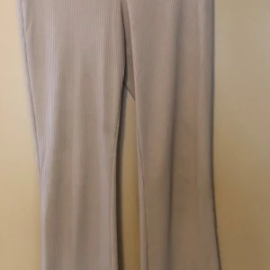 Beige ribbade manchesterbyxor - Snygga beige manchesterbyxor med ribbad struktur och raka ben. Byxorna har en klassisk passform och är perfekta för dig som gillar en stilren och trendig look. Materialet är mjukt och ger en skön känsla hela dagen.