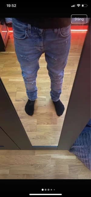 Blå slim  jeans med slitningar - Snygga blå jeans med slim passform och coola slitningar på både fram- och baksida. Klassisk femficksmodell med normal midja och smal siluett. Jeansen är gjorda i stretchigt denim för extra komfort och har en fräsch, modern look. W26 L28