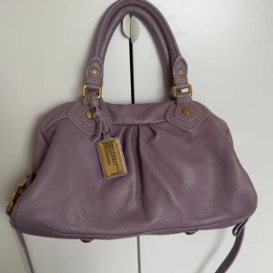 Marc jacobs väska - Otrolig Marc jacobs väska i så snygg färg. Jättefint skick inte använd mycket. Dustbag och avtagbart axelband medföljer. 