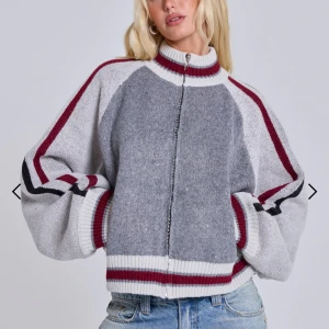 Grå kofta med röd-vita ränder - Snygg kofta i grått med vita och vinröda ränder längs ärmar och muddar. Dragkedja framtill, ribbade muddar och krage. Oversized passform med ballongärmar. Perfekt till jeans för en chill look. Inga lappar i om märke min syrra köpte i Paris ❤️ första bilderna är från jaded London då de är exakt lika dana!