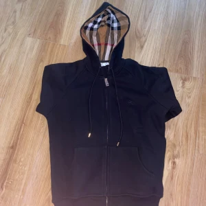 Svart Burberry hoodie med kort ärm - Svart hoodie från Burberry. Aldrig använd därför är de nyskick. Storlek S men passar XS.
