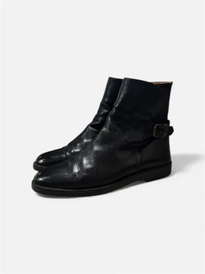 Svarta boots i skinn med spänne - Snygga svarta boots i mjukt skinn från Nordiska Kompaniet! De har ett coolt spänne på sidan och brunt innerfoder som ger lite extra stilighet! Osäker på nypris men över 3000 skulle ja tro baserat på nk priserna! Storlek 41, Pris är inte hugget i sten!