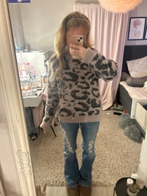 Blå lågmidjade bootcut jeans med fickdetaljer - Säljer ett par blå bootcut jeans med snygga slitningar framtill och dekorativa fickor bak med knappdetalj. Köpta för 420kr, Jeansen är i strl 170 ifrån ginatricot och har normal passform och klassisk jeanslook, perfekta till en unik stil.