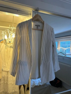 Vit randig kavaj - Snygg vit kavaj med svarta vertikala ränder.