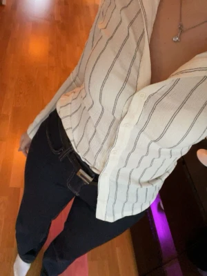 Vit randig skjorta med knappar - Vit skjorta med svarta ränder och. Långärmad modell med knäppning framtill, armen har en slits! Använd bara 1 gång så den är helt ny. PS! Jag skickar posten om du köper innan kl 17🥰