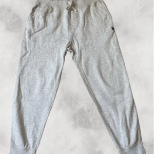 Ralph Lauren byxor  -   Supersnygga och sköna Ralph Lauren-byxor i klassisk ljusgrå färg. Mjukt och följsamt material med perfekt passform – resår i midjan, dragsnöre och muddar vid bensluten för en stilren look. 	•	Storlek: S 	•	Skick: Mycket bra, inga defekter 	•	Nypris: ca 1 400 kr 	•	Mitt pris: 459 kr  Byxorna var flång nya när jag köpte dem, och är fortfarande i toppskick! Perfekta både till vardags och till en avslappnad men lyxig outfit.  💨 Först till kvarn – Ralph Lauren gå