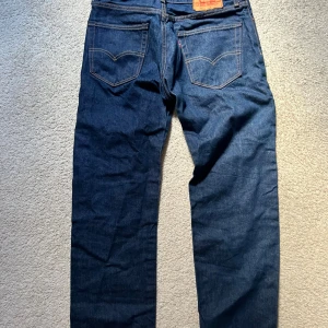 Levi's 505 mörkblå jeans W33 L32 - Klassiska Levi's 505 jeans i mörkblå tvätt. Midja: 41cm Ytterkant: 104cm Benöppning 21cm. Skicka gärna meddelande om du har någon fråga! 