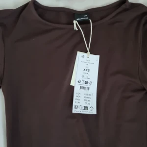 Brun långärmad topp från Gina Tricot - Mjuk och skön brun långärmad topp från Gina Tricot med rund halsringning. Modellen är slim och har en enkel, stilren design utan mönster eller detaljer. Perfekt för dig som gillar basic och vill ha en topp som är lätt att matcha med allt. Ny med prislapp