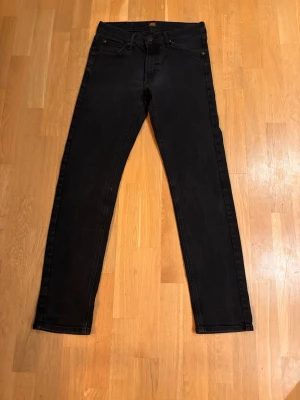 Lee Daren Zip Fly - DAREN ZIP FLY jeans från Lee Jeans är ett klassiskt och stilfullt val för alla tillfällen. Dessa jeans har en bekväm passform och en tidlös design som aldrig går ur stil. Viktiga funktioner Klassisk och stilren design Bekväm passform Egenskaper Dragkedja i grenen Fem fickor Passform Regular fit – raka från höfterna till låren och har en vidare öppning över anklarna än slim fit.