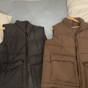 Västsr - 2 identiska västar, ena brun andra svart, båda storlek M i gott skick  Inköpt för 400kr styck 100kr styck