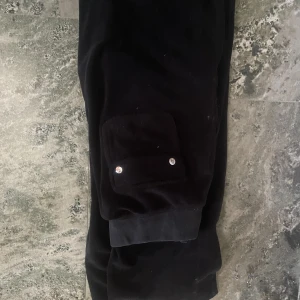 Juicy byxor xs - Svarta juicy byxor strl xs, täcken på användning finns, dom är lite utvättade men sitter fint ändå. Det är bara o buda! Högsta bud vinner💞 ena knappen sitter lite löst på backfickan, ingentinting som stör