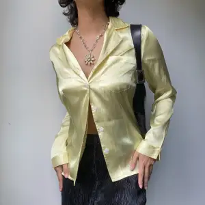 • SILKY LIGHT YELLOW FITTED SHIRT. SMALL PENCIL MARK ON SIDE.  • SIZE - Fits XS-S