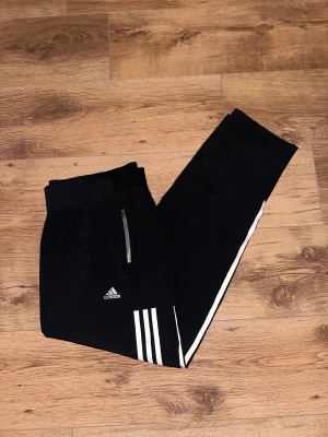 Träningsbyxor  - Helt nya och oanvända träningsbyxor från Adidas.   Rensar ur min garderob från en hel del oanvända kläder🌼 Kika och se om du ser något mer i min profil som du gillar så skickar jag med det till dig också!😊 Fler kläder kommer! 
