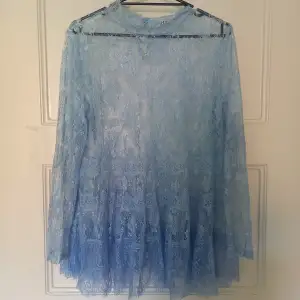 Beautiful blue lace blouse with high collar and a lovely button on the back