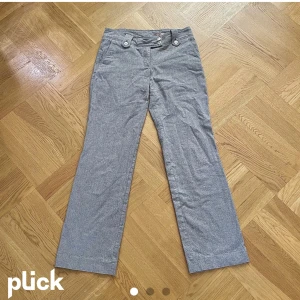 Gråa byxor - Ett par svinstiliga lågmidjade vida byxor från cue 🤍 Fräna detaljer vid bältet och fickorna