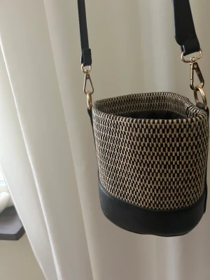 Väska - Liten fin väska med justerbart band. Kan ha den cross over eller över axeln. Fint skick.