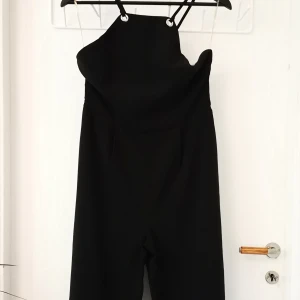 Jumpsuit - Straight line jumpsuit with metallic details on the top. Seamless zipper and great fit. Brand is Glamorous from Top Shop UK. 