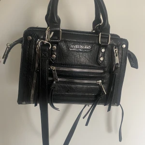 Väska - Säljer denna snygga väska! Då man kan välja att ha axelband eller ej, så funkar den både som handväska och axelremsväska✨ Den är rymlig med flera fack och i väldigt bra skick❣️Kan skicka mått vid intresse😇