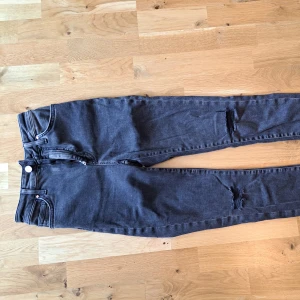 Jeans - Svarta rivna jeans med stretch. 