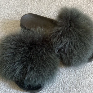 Äkta pälstofflor - Ett par snygga äkta pälstofflor i en mörkgrön färg, storlek 40, men passar 39. Väldigt fina och faktiskt väldigt bekväma och snygga till sommaren, knappt anväda och köpta för ungefär ett år sedan. Nytt pris 549kr men säljer för 219kr  Köpare = frakt