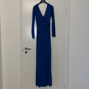 Byxdress - Blå byxdress i lyxigt material, något glittrande i vissa ljus. Använd endast 1 gång! 