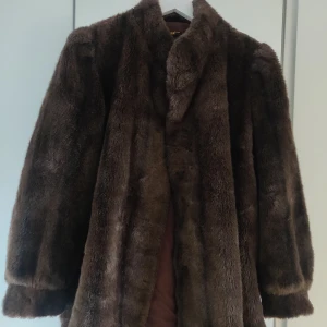 Jacka i fuskpäls  - Jättefin vintage jacka som jag knappt använt. Den är varm och kan användas på vintern med. Problemet är att den har alltid varit för stor för mig,just vid axlarna. Samt en ögla är borta längst upp vid halsen. Därav pris. Annars en fin jacka. Bilder finns!