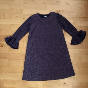 Klänning, barn - En lila glittrig klänning i storlek 146/152 10-12 år. Passar perfekt för exempelvis nyår eller annat festligt. Mycket bra skick.