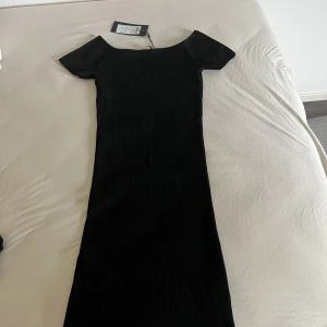 Helt ny ribbad klänning - Helt ny oanvänd svart ribbad klänning, off shoulder. Lappen finns fortfarande kvar