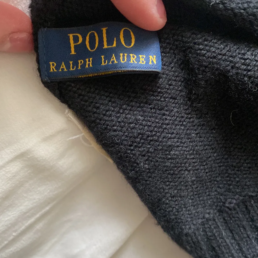 Svart ullmössa från Polo Ralph Lauren, loggan är broderad i grått.. Accessoarer.