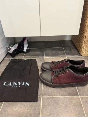 Lanvin - Mörkröda lantvins i sällsynt colorway. Uk 9 vilket är ungefär 43 i storlek. Det är i väldigt gott i skick förutom ett litet hål på sidan, därav sänkt pris. Tveka inte att höra av dig vid funderingar!