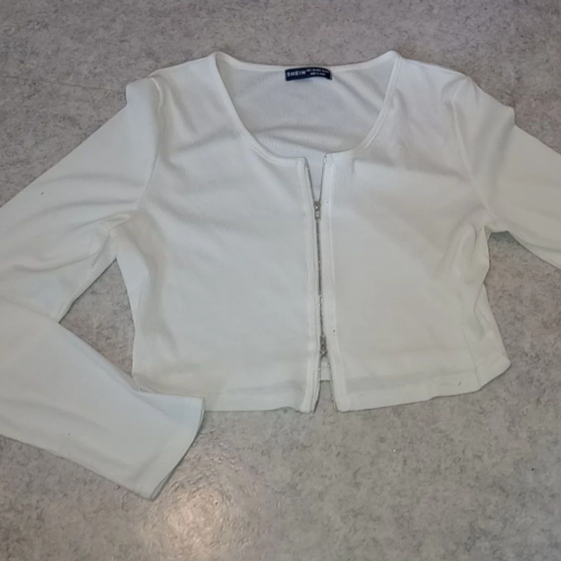 Topp dubbeländad dragkedja vit