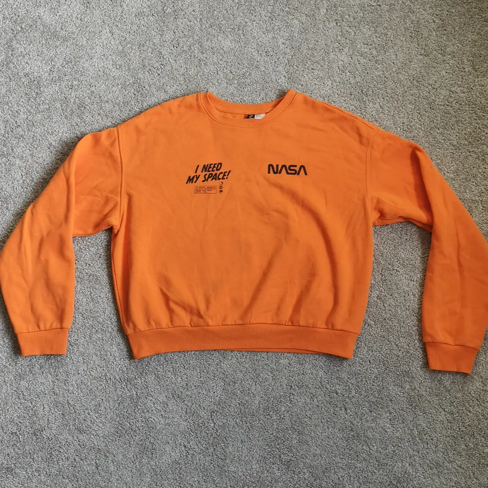 En supersnygg och skön collegetröja i orange färg. Har tryck på framsidan och i storlek M från divided. . Tröjor & Koftor.