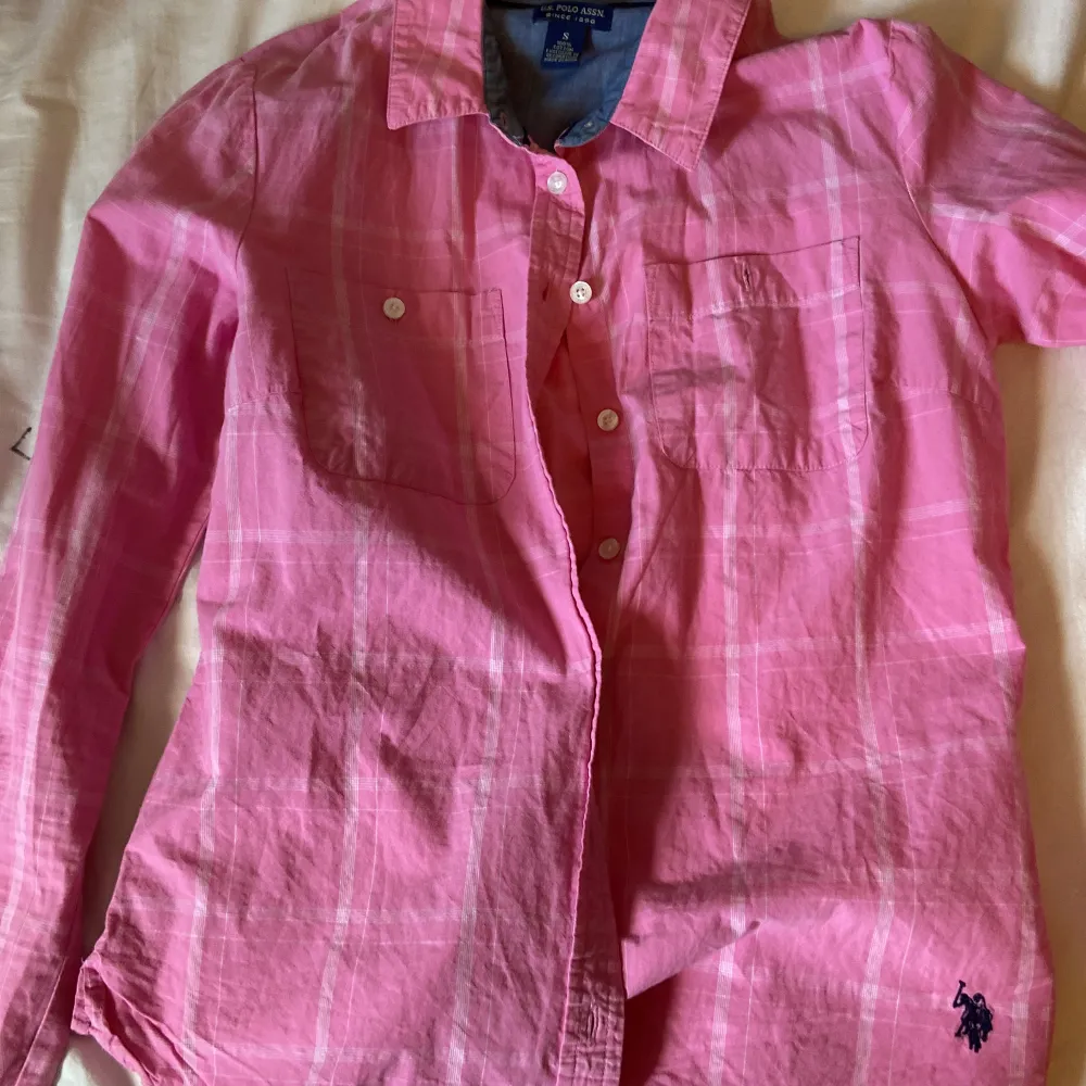 En rosa polo skjorta. Skjortor.
