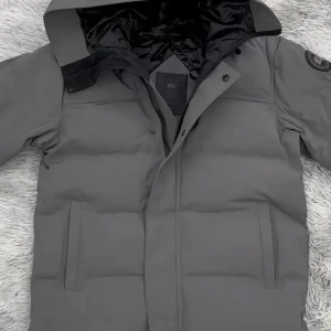 Svart Canada Goose  - Har haft den sen i september, den har ett litet hål i högra armhåla men gå att sy jätte lät. 